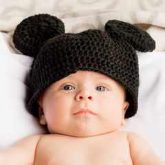 Two month baby with a black wool hat