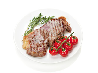 Sirloin steak with rosemary and cherry tomatoes on a plate