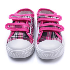 Pink sneakers for a baby on white background - obrazy, fototapety, plakaty