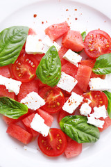 Salad with watermelon, feta and basil leaves
