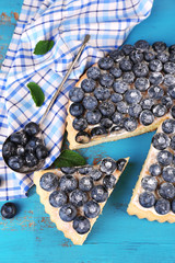 Tasty homemade pie with blueberries on wooden table