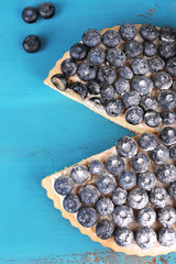 Tasty homemade pie with blueberries on wooden table