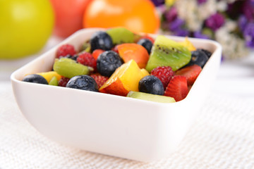 Delicious fruits salad in plate on table close-up