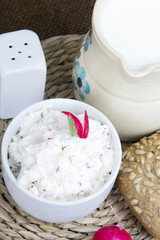 cottage cheese with radish, milk jug and wholemeal bun