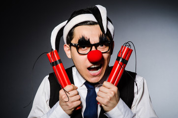 Funny clown with sticks of dynamite