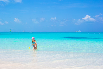 Fototapeta na wymiar Little adorable girl at beach during caribbean vacation