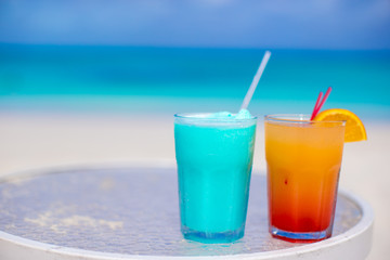 Close up tasty cocktails on the white sandy beach