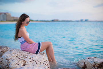 Fototapeta na wymiar Young woman enjoying vacation on white tropical beach