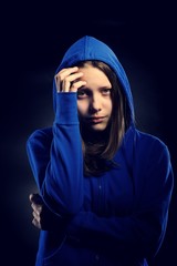 Afraid teen girl in hood