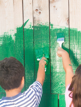 young girl and boy painting