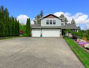 House exterior with curb appeal. View of garage and driveway