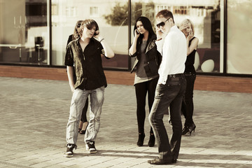 Group of young fashion people calling on the phones