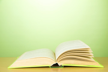 Opened book on color background
