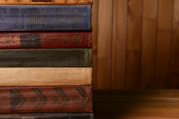 Old books on table on wooden background