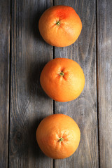 Ripe grapefruits on wooden background