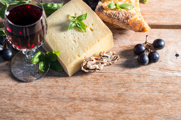 cheese with red wine, walnuts, basil leaves and grapes