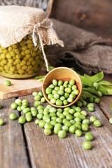 Fresh  and canned peas in bowl and glass jar