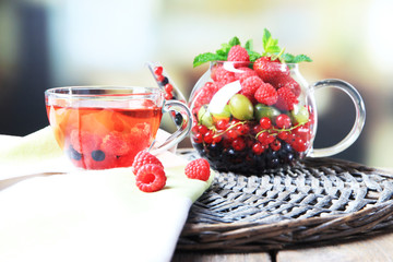 Fruit red tea with wild berries in glass cup,