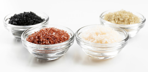 Different sea salt in bowls close up