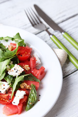 Salad with watermelon, feta, arugula and basil leaves
