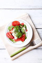 Salad with watermelon, feta cheese, arugula, tomatoes, sesame