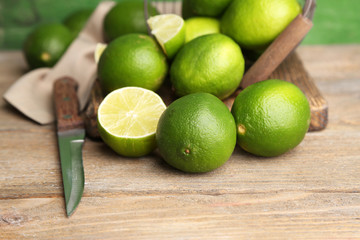 Fresh juicy limes on old wooden background