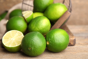 Fresh juicy limes on old wooden background