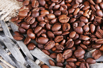 Coffee beans on wicker mat background