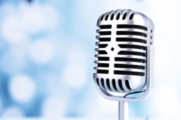 Fototapeta na wymiar Vintage microphone on light blue background
