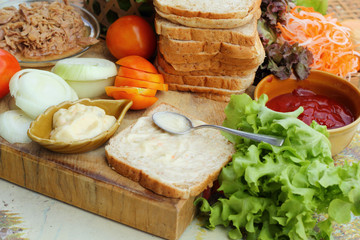 making tuna sandwich with fresh vegetables