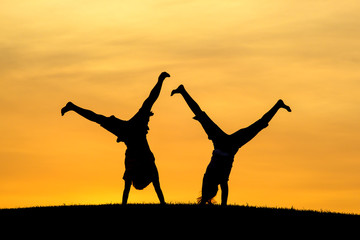 Doing cartwheels together.