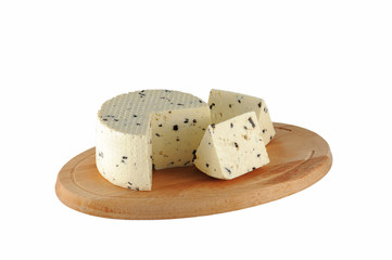Cheese with olives on wooden cutting board