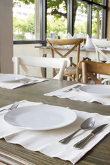 Table setting with fork, knife, plates, and napkin