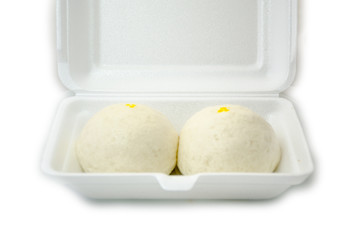 Two Chinese steamed buns in white box isolated on white backgrou