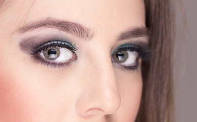 closeup of attractive young woman wearing makeup posing