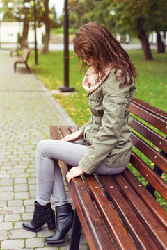 woman sitting bench outside