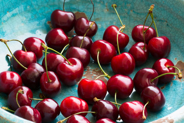 Red cherries in antique bowl