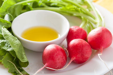 fresh radish and olive oil on plate