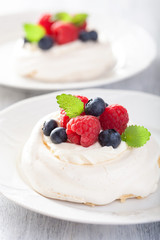 pavlova meringue cake with cream and berry