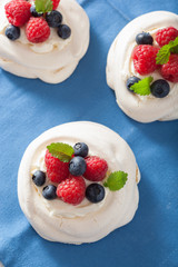 pavlova meringue cake with cream and berry