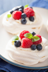 pavlova meringue cake with cream and berry