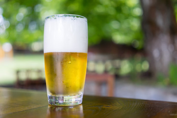 Glass of beer on wooden table