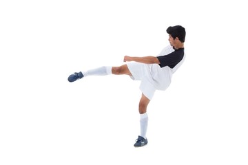 Fototapeta na wymiar Football player in white kicking