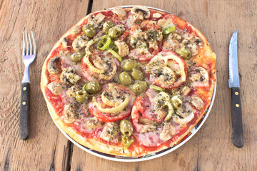 Delicious italian pizza on wooden background