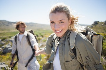 Hiking couple standing on mountain terrain