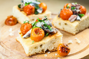 Delicious focaccia with sardines and cherry tomatoes