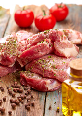 Raw steak over wooden background