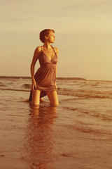 Fototapeta na wymiar Woman on the beach at sunset.