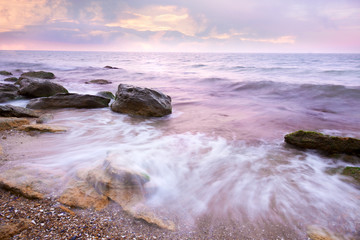 Colorful  Sunrise over the Sea and Rocky Coastline ,  flowing wa