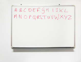 Literacy. Alphabet on real whiteboard in real classroom with rea